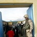 U.S. Soldier Engages with Afghan Girl at Newly Renovated School
