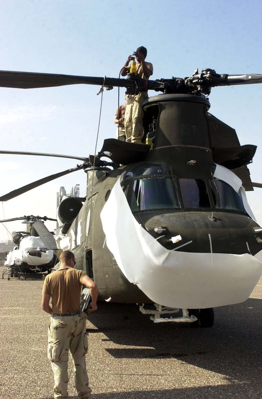 Soldiers Prepare Chinook Helicopter for Shipment in Kuwait