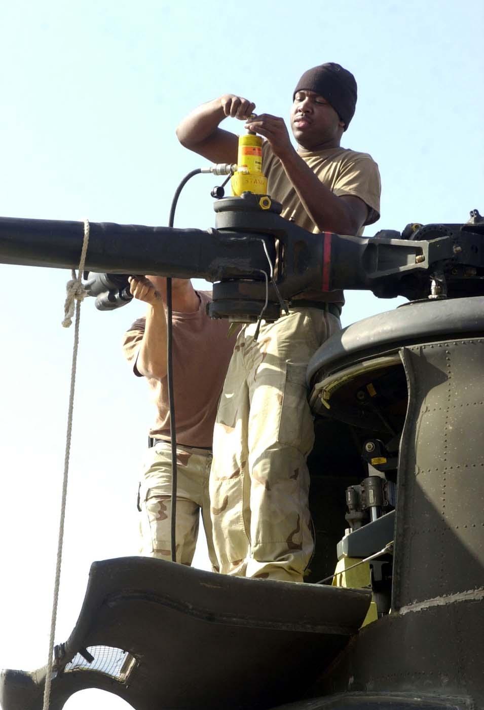 Soldiers Prepare Chinook Helicopter for Shipment in Kuwait