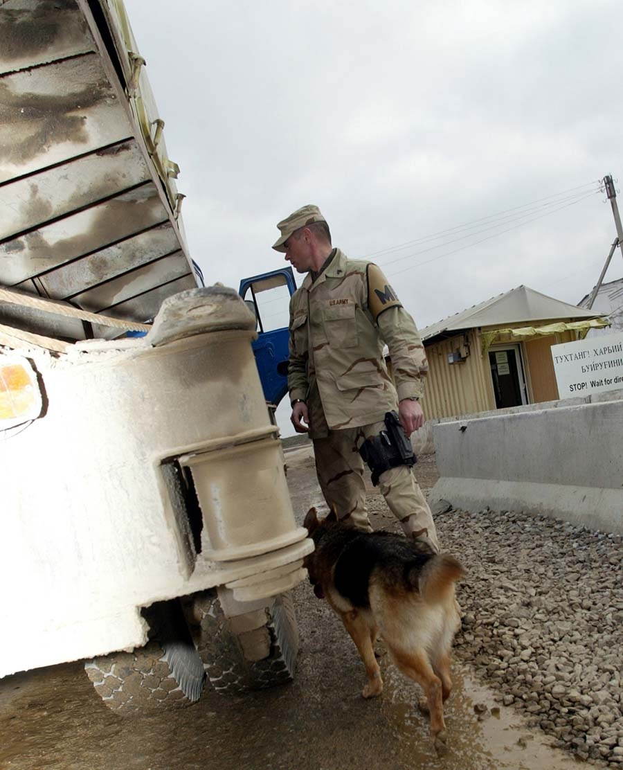 Military Police and Working Dog Inspect Truck at Camp Stronghold Freedom