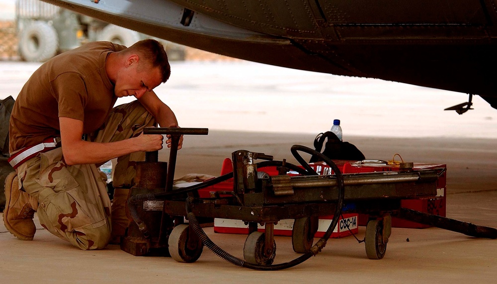 Airman Replaces Flat Tire on C-130 During Iraqi Freedom Mission