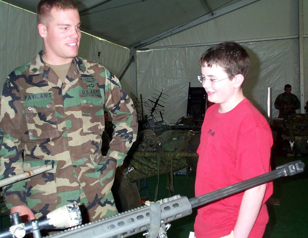 Army Ranger Showcases Weaponry to Student at Public Service Expo