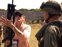 Military Official Examines Weapons Used by Marine Corps Security Force