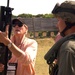 Military Official Examines Weapons Used by Marine Corps Security Force