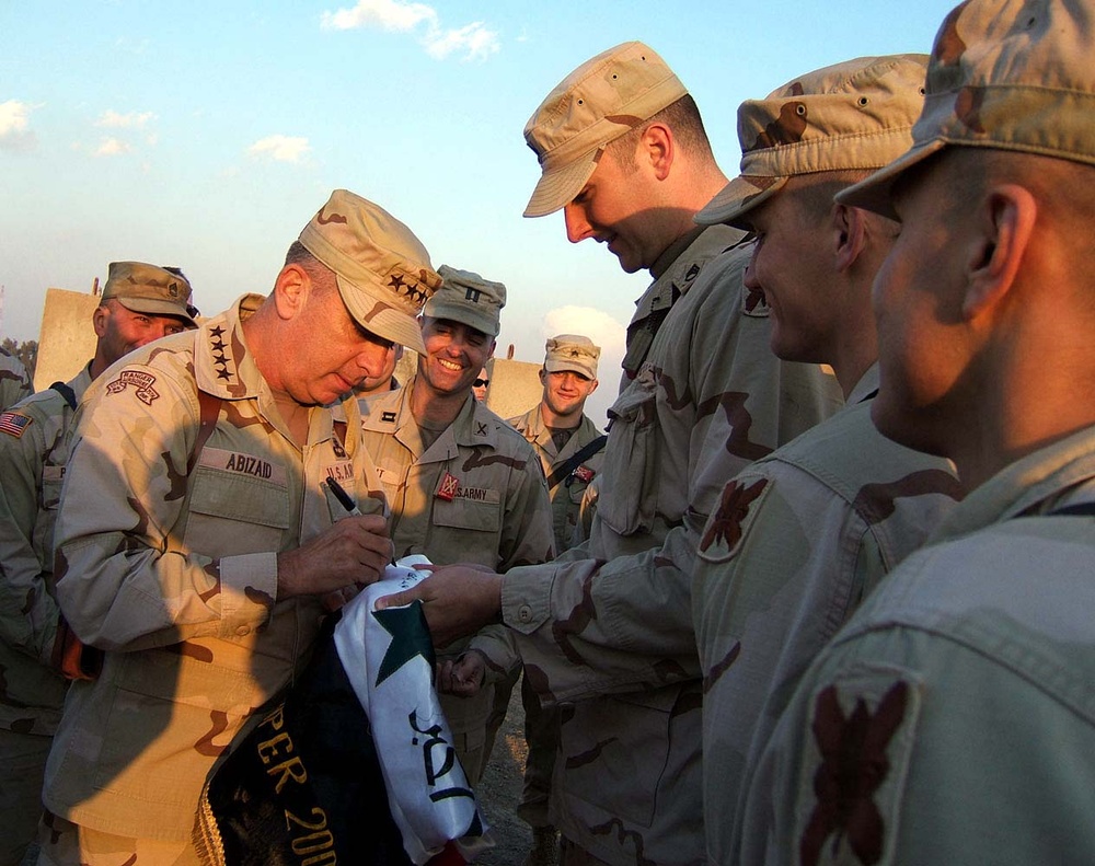 Army Gen. Abizaid Signs Iraqi Flag for U.S. Troops in Baghdad