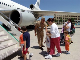 Rear Admiral Encourages Evacuated Families Boarding Flight Home from Italy