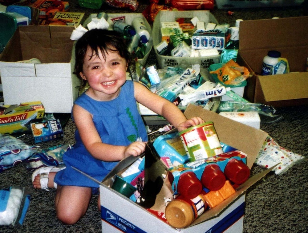 Young Girl Helps Pack Boxes for SI Yellow Ribbon Campaign