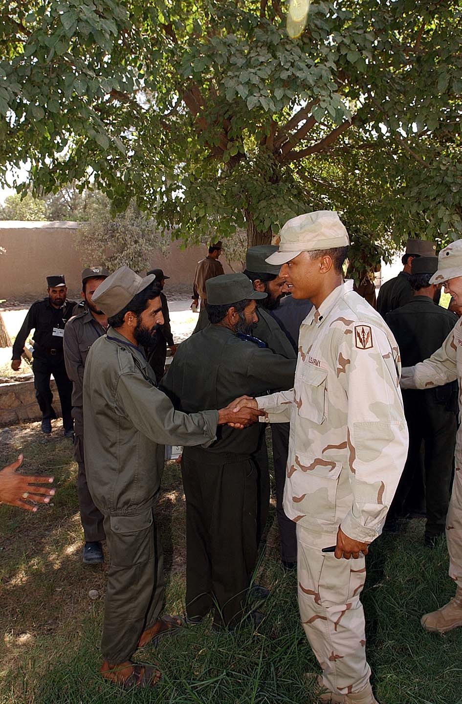 U.S. Soldier Congratulates Afghan Policeman After Training Course