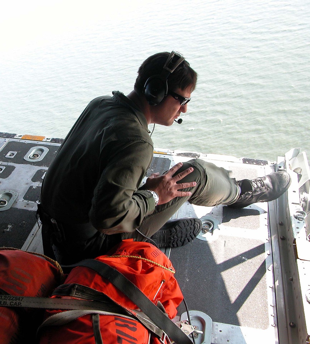Petty Officer Scans Waters from C-130 During Search and Rescue Operation