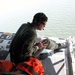 Petty Officer Scans Waters from C-130 During Search and Rescue Operation