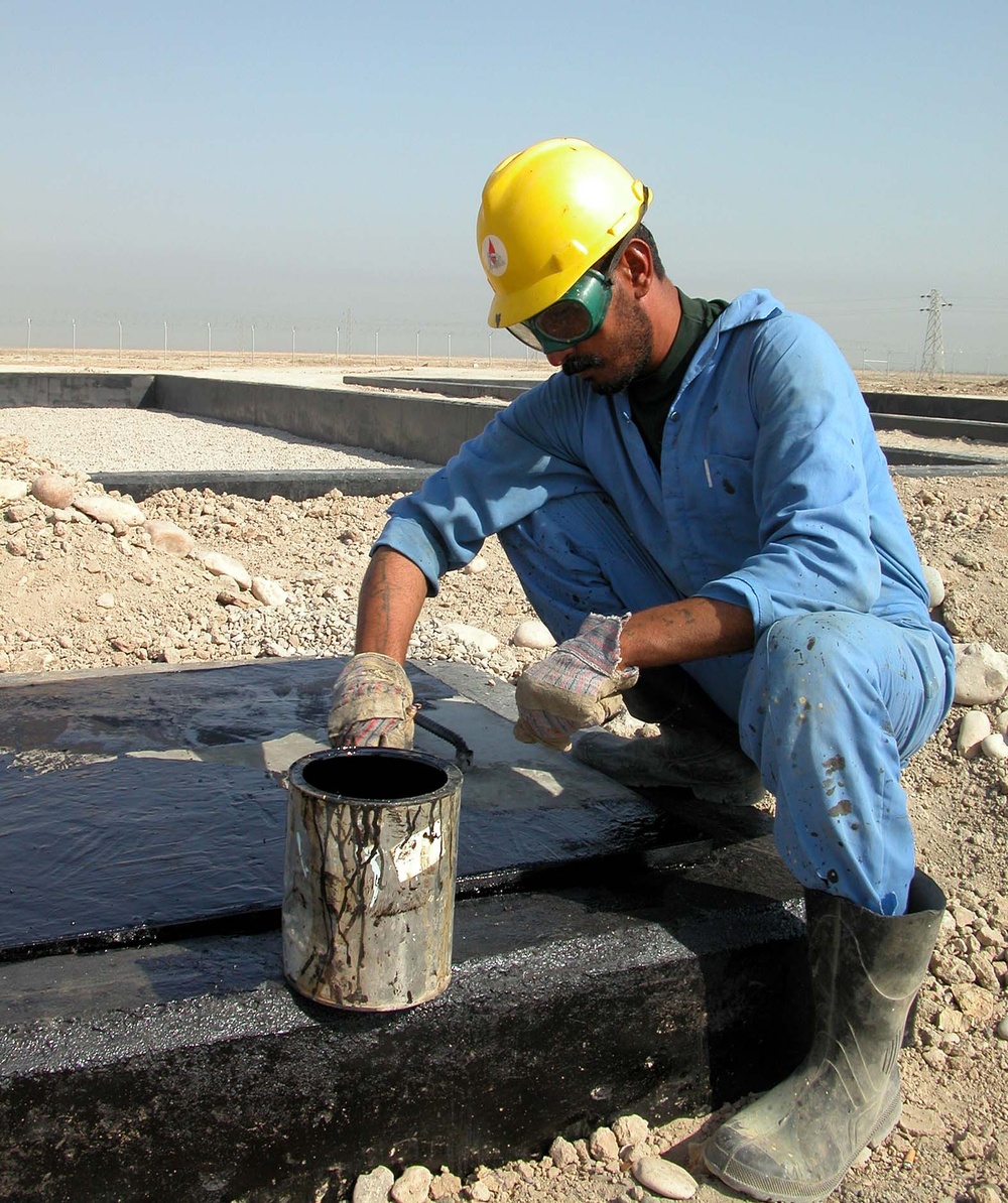 Iraqi Laborers Seal Concrete at Basra Sewage Treatment Plant