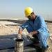 Iraqi Laborers Seal Concrete at Basra Sewage Treatment Plant