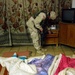 Soldier Searches Drawers as Iraqi Child Sleeps Undisturbed