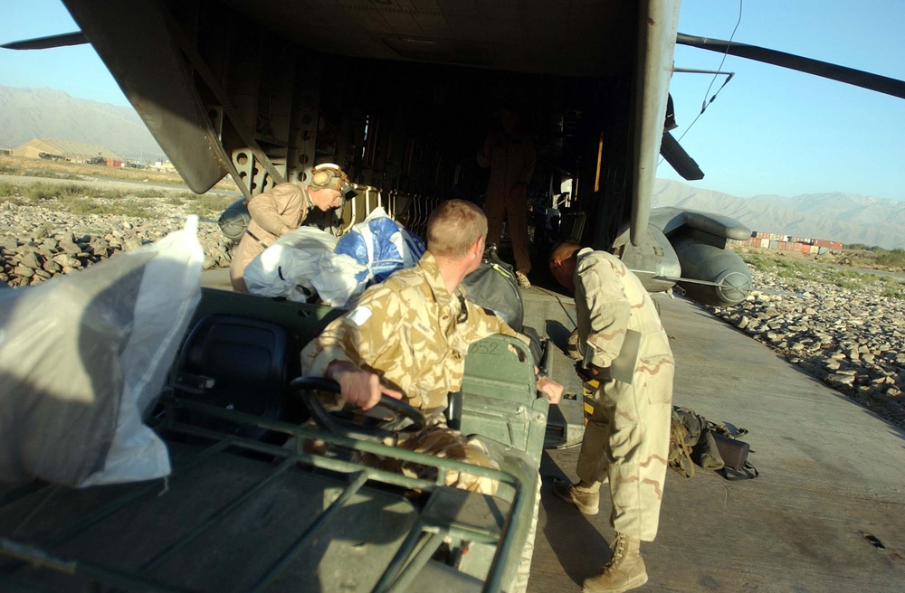 New Zealand Soldier Loads All-Terrain Vehicle onto U.S. Marine Helicopter