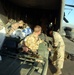 New Zealand Soldier Loads All-Terrain Vehicle onto U.S. Marine Helicopter