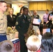 Army Recruiter Plays National Anthem as Marine Recruiter Stands at Attention