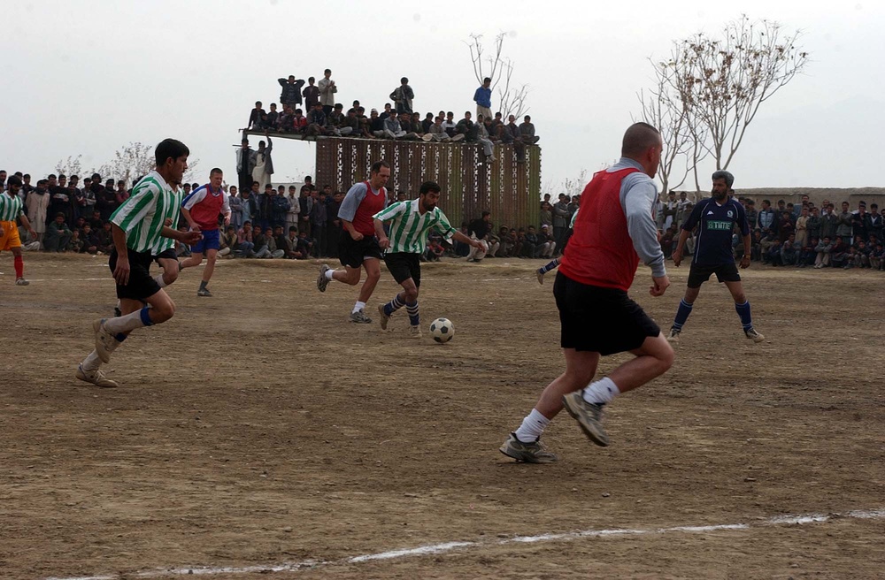 Afghan Player Dribbles Past Coalition Defenders in Match