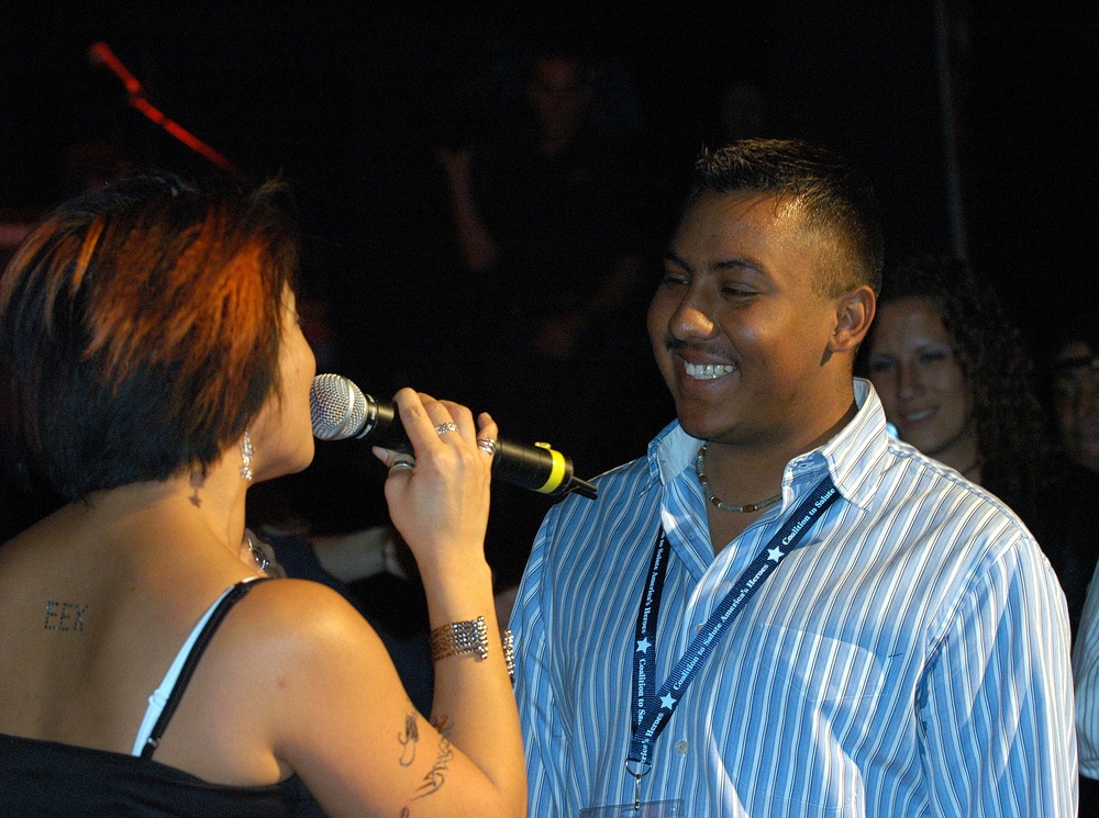 Soldier Dances with Singer at Tribute Concert