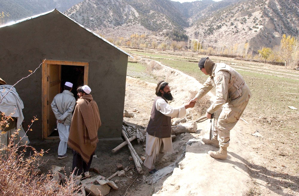 Army Sergeant Engages with Afghan Civilian During Well Assessment