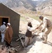 Army Sergeant Engages with Afghan Civilian During Well Assessment