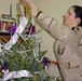 Soldier Decorates Christmas Tree at Army Base