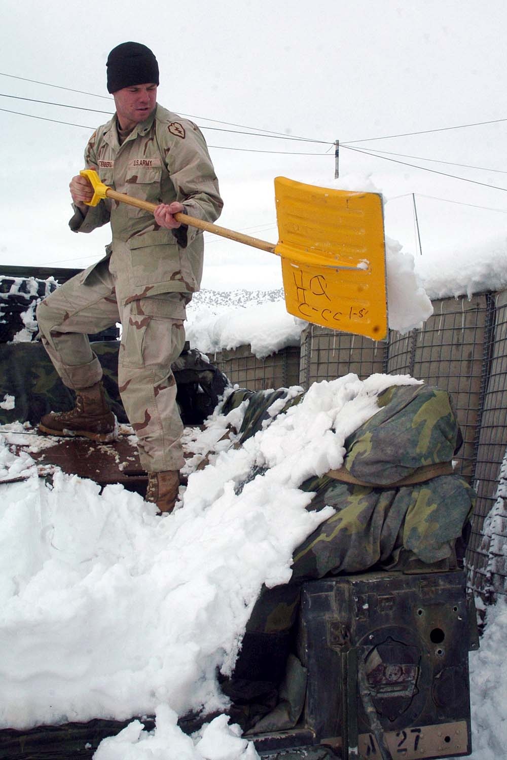Medic Shovels Snow at Forward Operating Base in Afghanistan