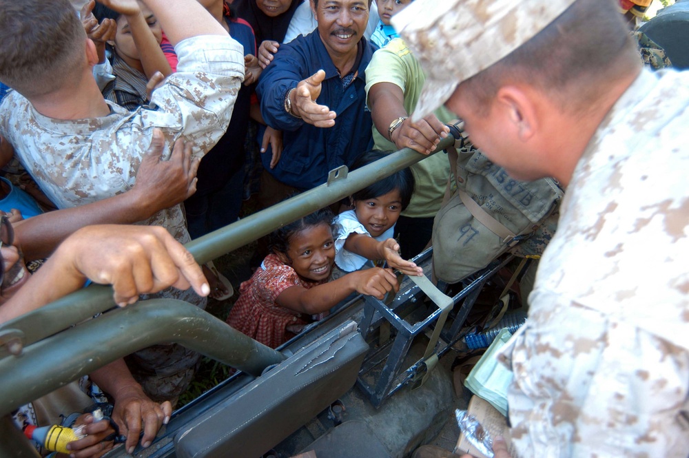 Marine Hands Out Treats to Indonesian Girl at Hospital