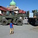Indonesian Boy Watches U.S. Marines Unload Water at Refugee Camp