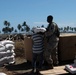 U.S. Sailor Assists Indonesian Resident with Disaster Relief Supplies