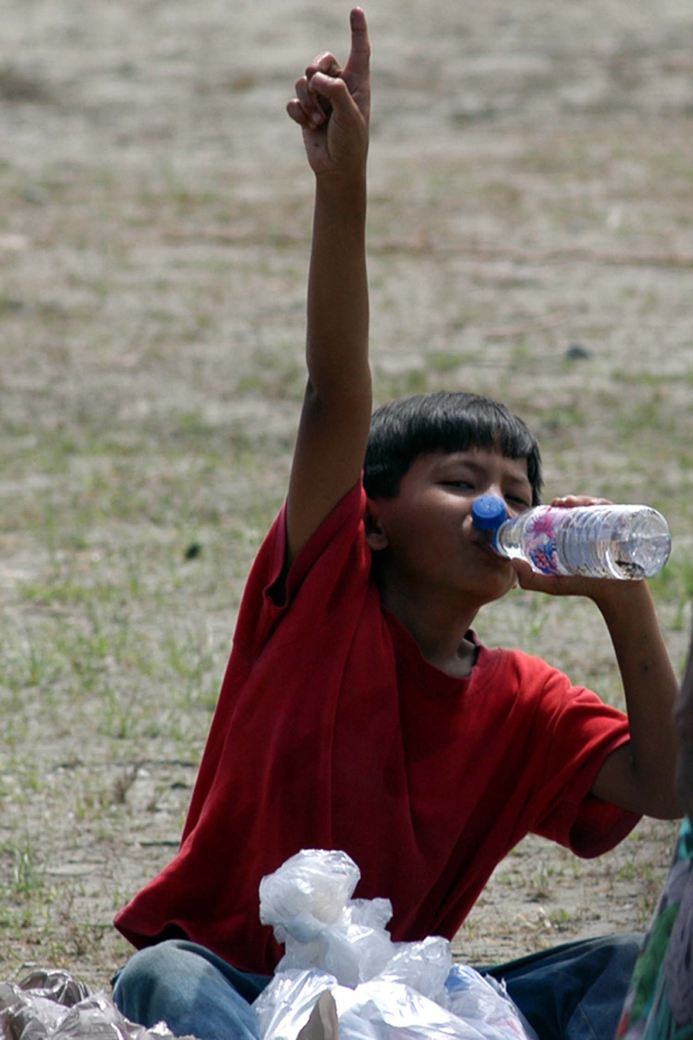 Young Boy Quenches Thirst After Earthquake and Tsunami in Sumatra