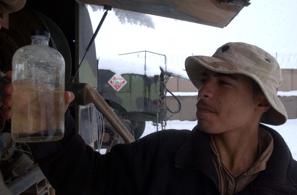 Soldier Inspects Fuel During Daily Safety Check