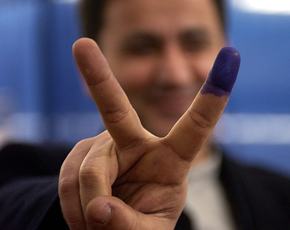 Iraqi Voter Celebrates Casting Ballot in U.S. Absentee Election