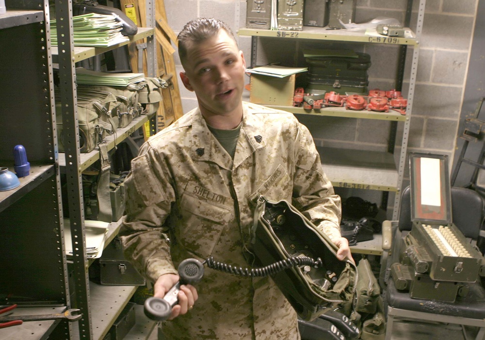 Marine Sergeant Maintains Cryptological Gear in Wire Cage