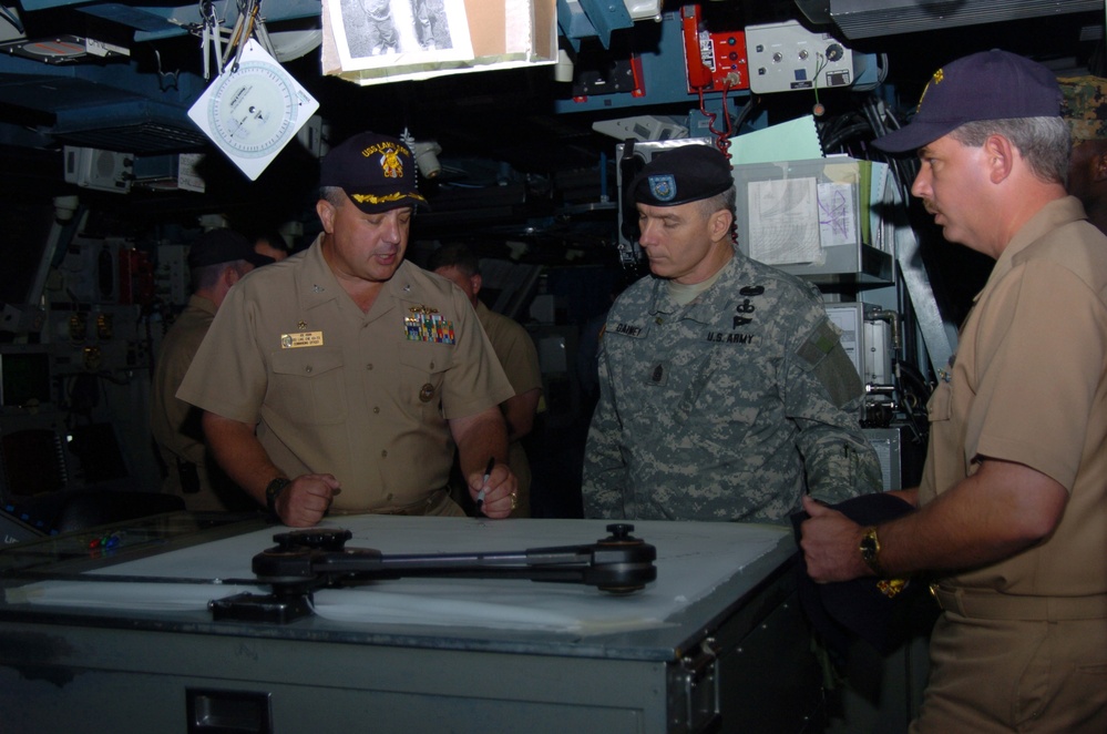 Navy Commander Explains Weapons Systems to Army Senior Enlisted Advisor