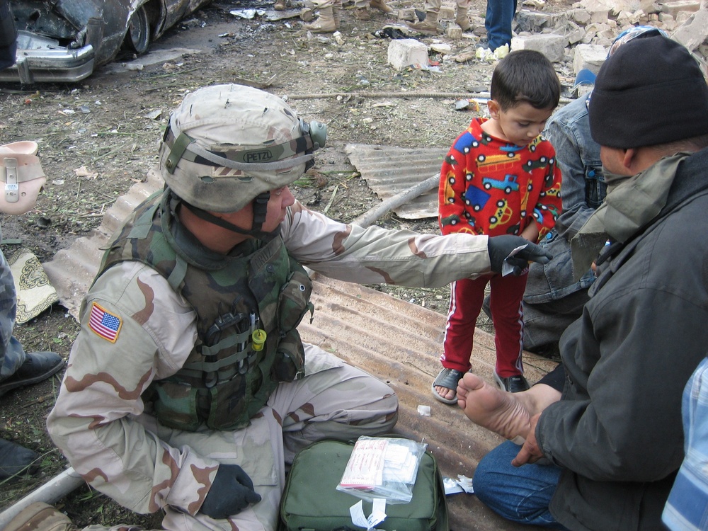 Medic Tends to Injuries After Baghdad Car Bombings