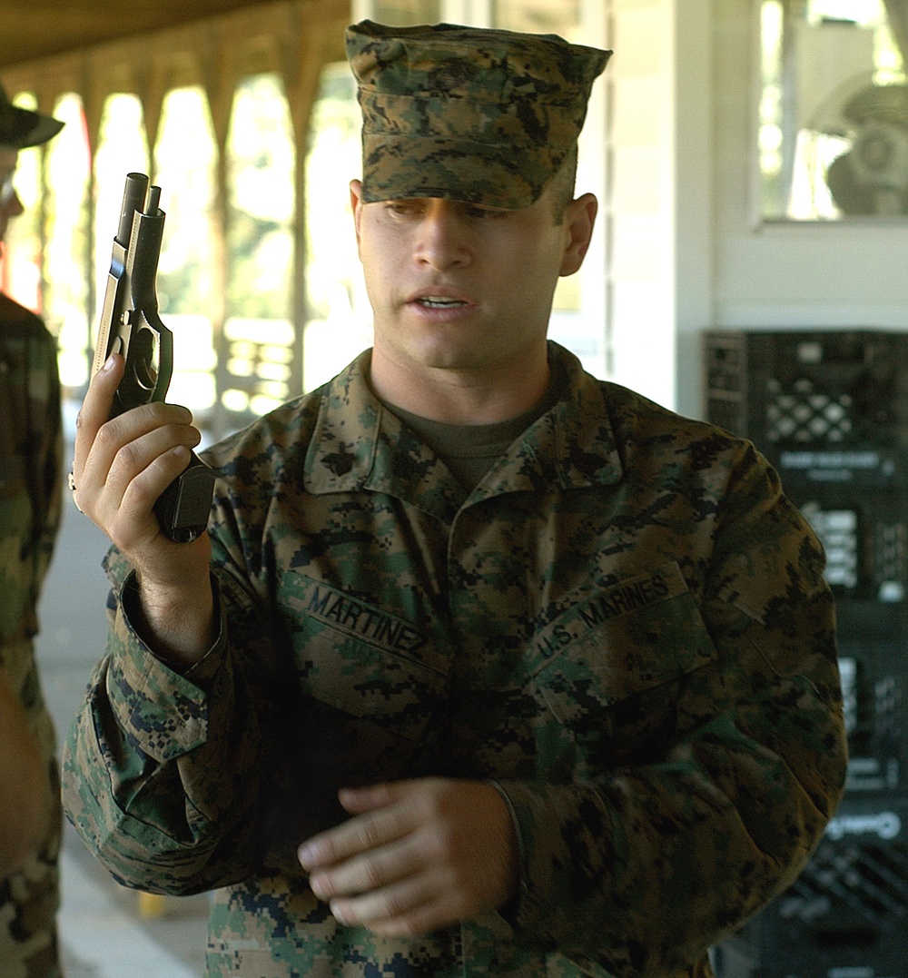 Marine Sgt. Explains Pistol to Civilian Professionals at Quantico