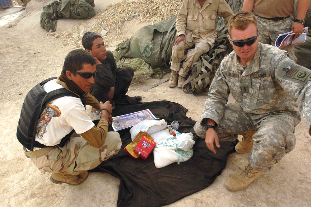 Airborne Infantry Officer Distributes Supplies to Afghan Villagers