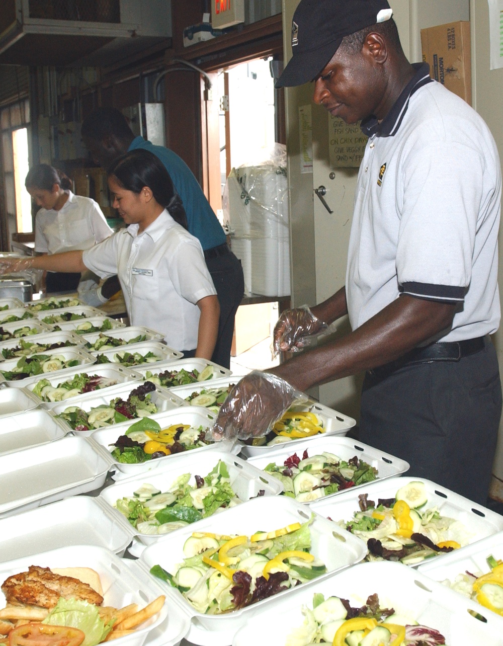 Contracted Food Service Workers Prepare Meals for Detainees at Guantanamo Bay