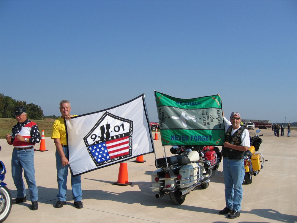 Motorcyclists Hold Flags for 9/11 &quot;Rattle the Runway Ride&quot;