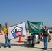 Motorcyclists Hold Flags for 9/11 &quot;Rattle the Runway Ride&quot;