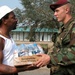 Algiers Resident Receives Water Aid from Army Paratrooper