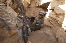 Army Soldier Inspects Demolition Charge in Iraq Cave