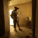 Soldier Searches for Weapons Caches in Iraq