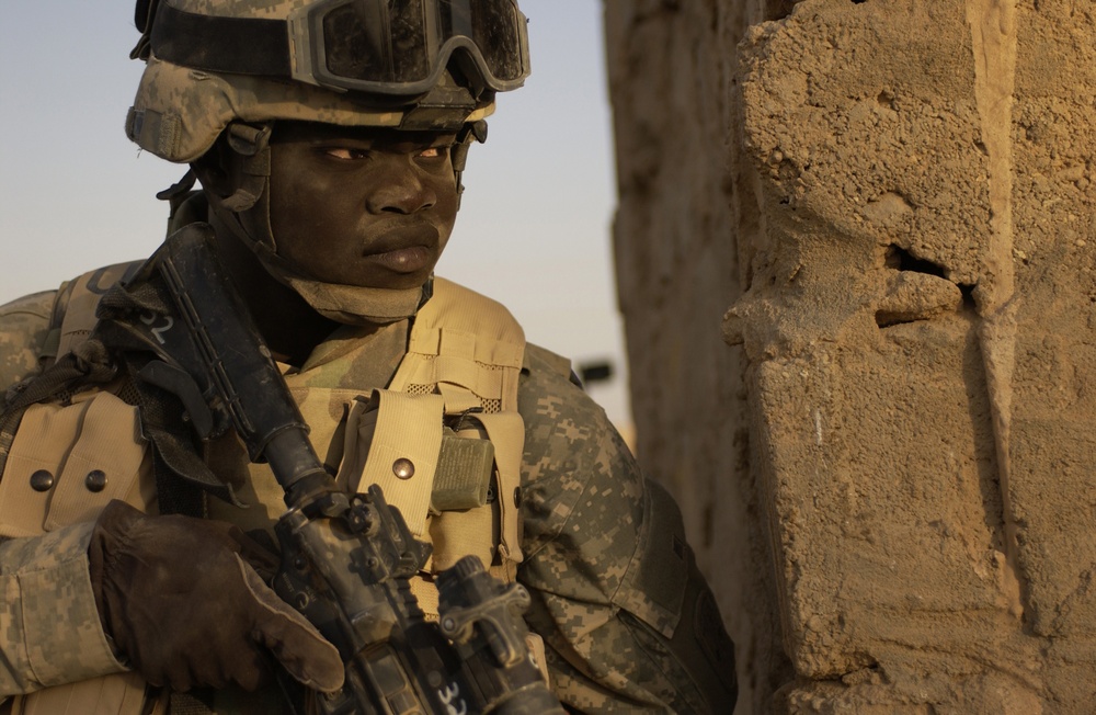 Soldier Provides Security During Weapons Search in Iraq