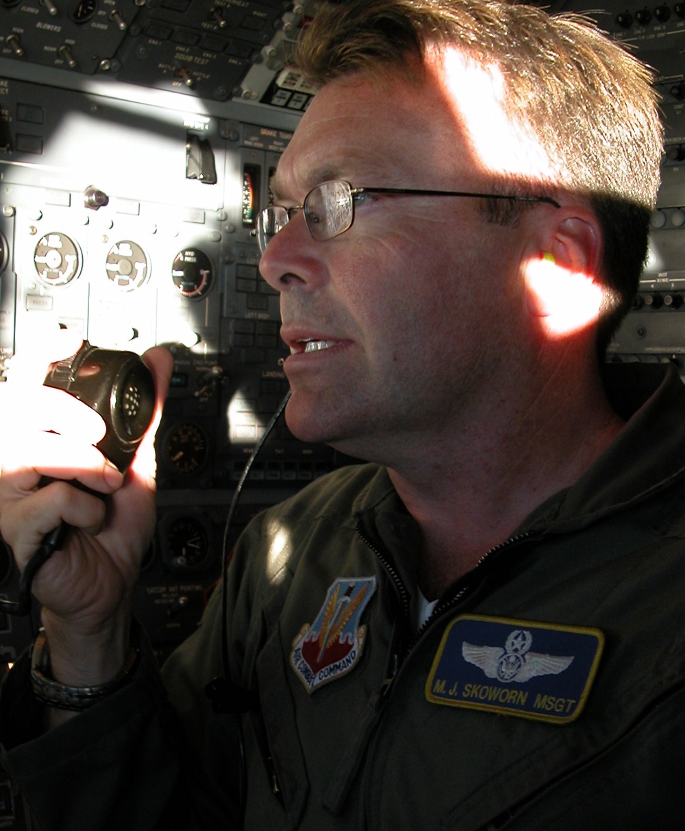 Air Force Flight Engineer Maintains Radio Contact During Aerial Refueling for Defense Secretary's Aircraft
