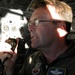 Air Force Flight Engineer Maintains Radio Contact During Aerial Refueling for Defense Secretary's Aircraft