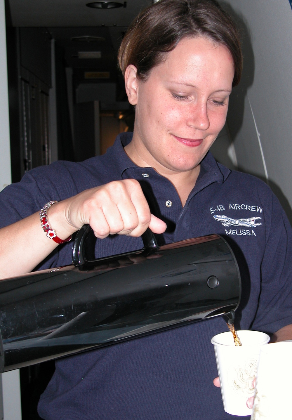 Air Force Flight Attendant Serves Coffee to Defense Secretary Rumsfeld