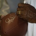 Pro Football Hall of Famer Gale Sayers Signs Football for Servicemember During USO Tour in Kuwait