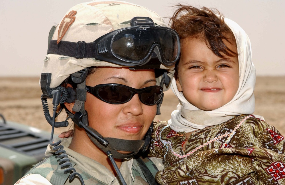 Texas National Guard Soldier Befriends Iraqi Child During Civil Affairs Mission
