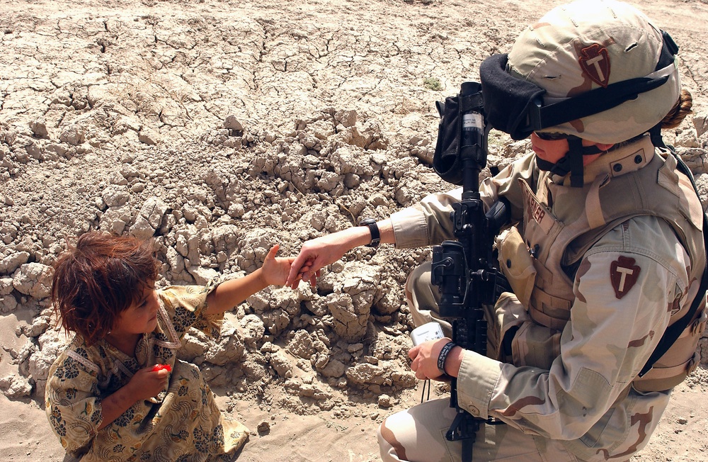 Texas National Guard Soldier Connects with Iraqi Girl During Village Visit